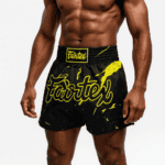 High-quality Muay Thai shorts with bold yellow branding from Baba Saleh Sports Egypt.